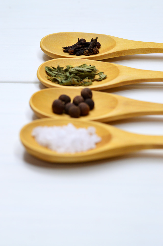 four spoons with spices